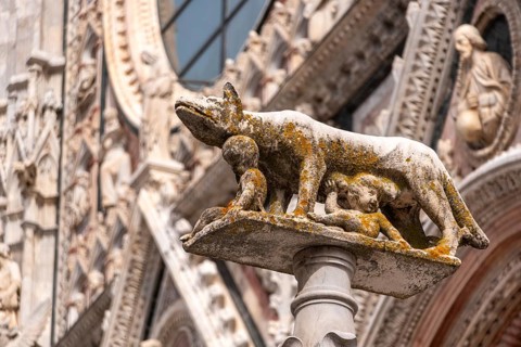 Statue of Romulus and Remus being fed by the wulf, at the central square of Siena, Italy, Europe