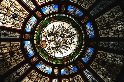 Bad Homburg, Germany - May 19, 2018: The colourful motif-painted windows of the entrance dome of