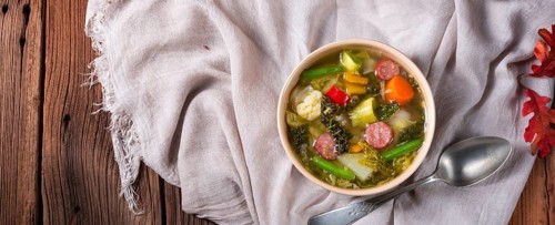 Delicious autumn vegetable soup with sausage and bacon