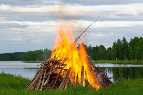A big fire at a lake shore on Midsummer Day, Finland, Europe