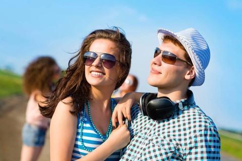 Young couple standing on the road, having fun with friends