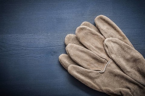 Two protective gloves on wooden board