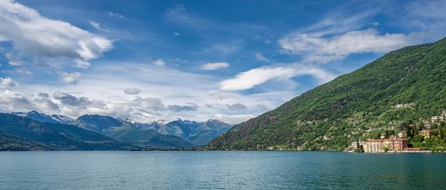 A view of the Bay of Bellano on Lake Como in summer under a blue sky