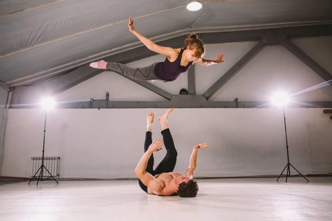 Young couple Couple practicing acro yoga in gym. Healthy lifestyle. Acroyoga. Couple yoga. Partner