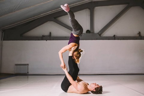Yogi couple practice. Couple young sporty peoplepracticing acrobatic yoga lesson with partner, man