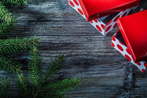 Wrapped present box pine branches on vintage wooden board