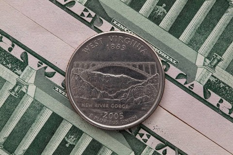A quarter of West Virginia on US dollar bills. Symmetric composition of US dollar bills and a