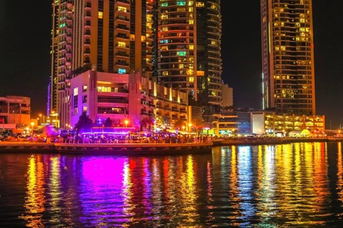 Dubai Marina Walk illuminated at night. Dubai Marina is a newly futuristic district, famous for