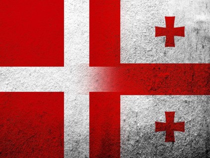 The Kingdom of Denmark National flag with flag of the country of Georgia. Grunge Background