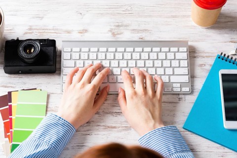 Freelancer sitting at desk and typing on keyboard. Business occupation and innovation. Office