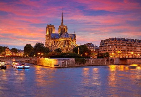 Notre Dame cathedral in Paris sunset from Seine river in France