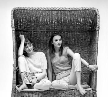 In the 1960s. Two fashion models, in typical 1960s summer outfits photographed in a studio wearing