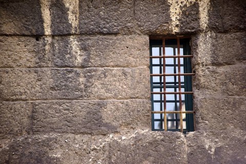 The nostalgic window of an old building with escape-proof iron bars as window grilles
