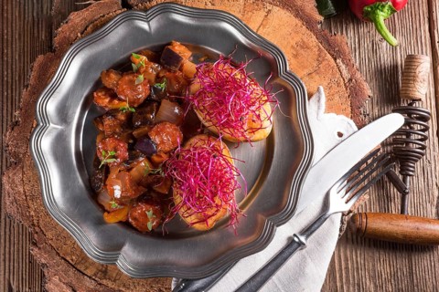Ratatouille with baked potato and beetroot sprouts
