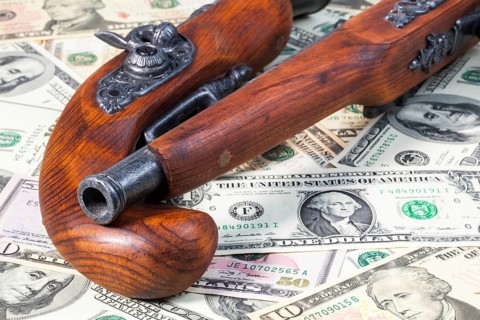 Old guns and dollar bills on the table