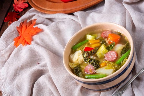 Delicious autumn vegetable soup with sausage and bacon