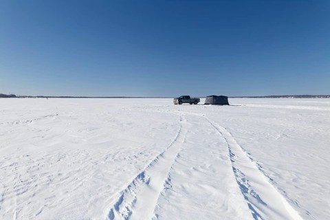 Winter, truck next to a icefishing tent on the frozen Saint Lawrence River, Province of Quebec,