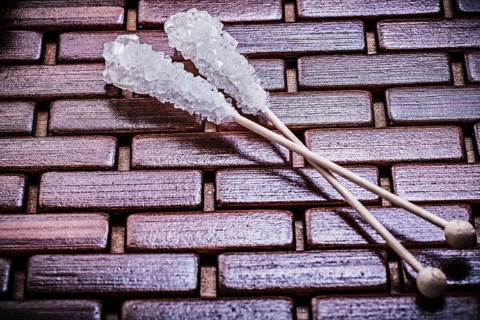 Sweet sugar sticks on wooden matting food and drink concept