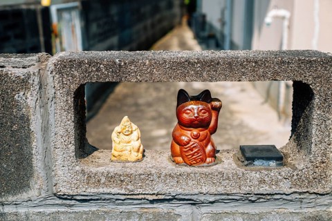 Japanese lucky cat maneki neko at Japanese old village Uchiko town in Ehime, Shikoku, Japan, Asia
