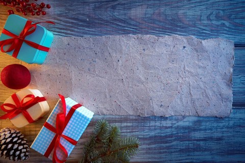Christmas gifts and blank paper recycled background fir and cones