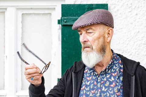 An image of an old man and his glasses