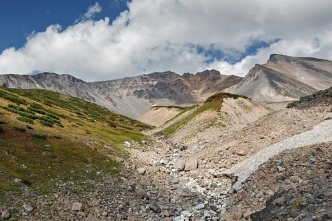 Summer volcanic landscape of Kamchatka Peninsula: beautiful view of Dzenzur Volcano, active volcano