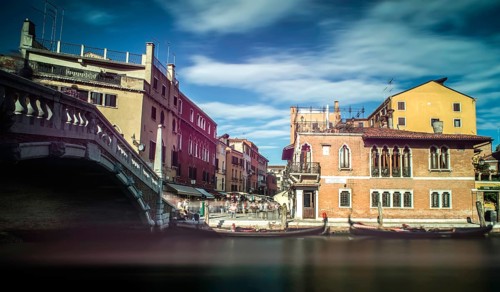 Ancient buildings and boats in the channel in Venice