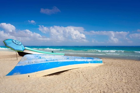 Tulum Caribbean turquoise beach boat in Riviera Maya of Mayan Mexico