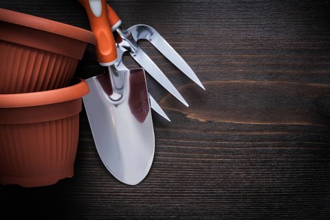 Clay gardening pots trowel fork and hand spade on vintage wood board agriculture concept