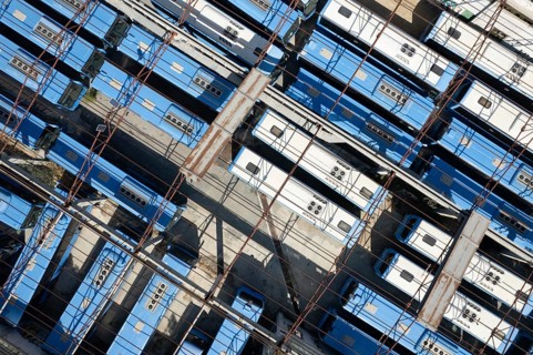 Drone aerial top view.photo of abandoned transport Blue buses parking. shabby and broken vehicle.