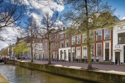 View of Delft canal with historic houses, Netherlands