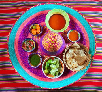 Assorted Mexican sauces spices chili pico gallo on Mexican colorful hat