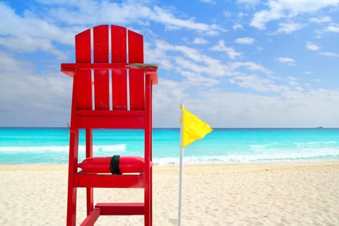 Baywatch red beach seat yellow wind flag in tropical caribbean sea