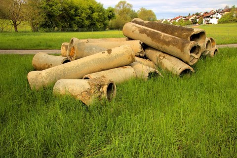 Dismantled concrete pipes in a meadow