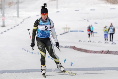 Korean sportswoman biathlete skiing at finish after rifle shooting. Lee Hyunju South Korea during