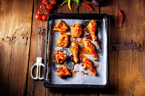 Rustic backed chicken wings, legs on baking tray