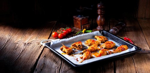 Rustic backed chicken wings, legs on baking tray