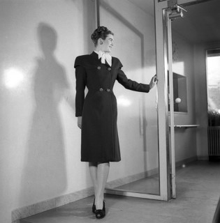 Women's fashion in the 1940s. A young woman in a typical 1940s coat. Photographed in full figure