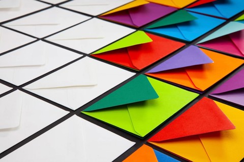 Composition with white and colored envelopes on the table. The photo suitable for various holidays