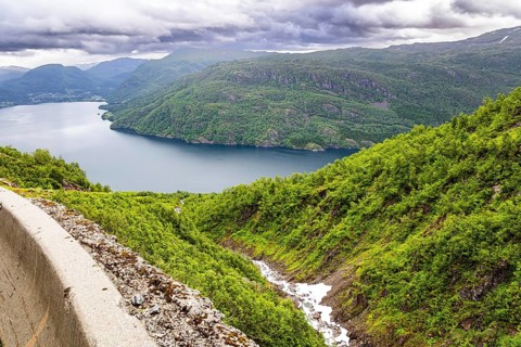 Magnificent panorama of the fjord. Norway. Traveling by camper on road 520. The road is fenced with