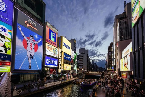 OSAKA, JAPAN - SEPTEMBER 24 2024: The view down Dotonbori River from Ebisubashi Bridge on a clear