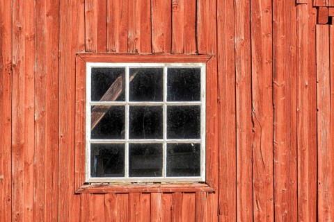 Window on a red weathered barn