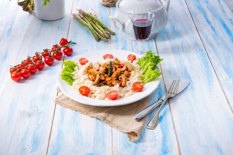 Turkey fricassee on rice with asparagus and peppers
