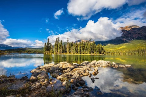 The autumn morning in the Rocky Mountains of Canada. Charming little island in the Pyramid Mountain