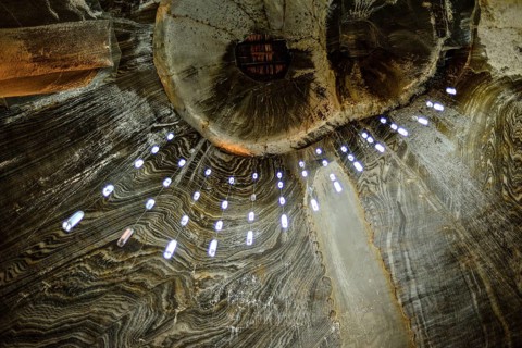 A view of the ceiling in the historic Salina Turda salt mine in Romania called owl's eyes