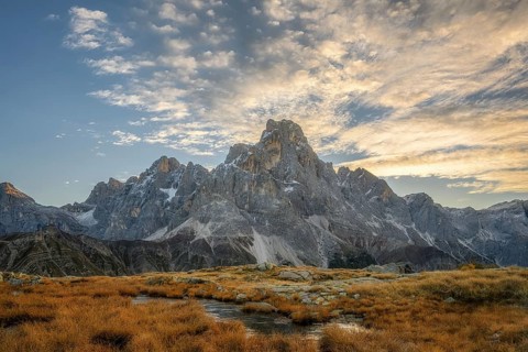 Cimon delle Pala mountain above Passo Rolle with white clouds