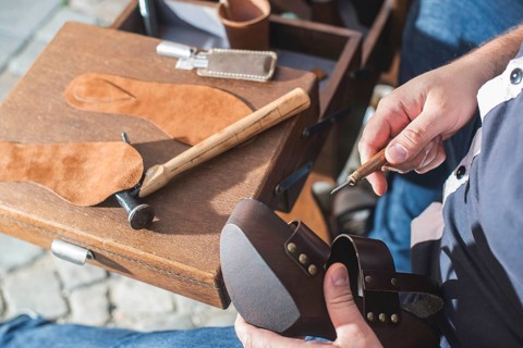 Hands making shoes. Shoemaker