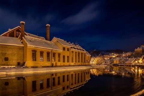 Winter view of Cesky Krumlov, picturesque houses under the castle with snow-covered roofs. Narrow