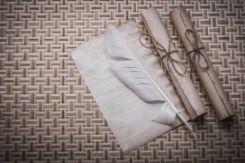 Rolls of vintage paper clean sheet quill on woven matting