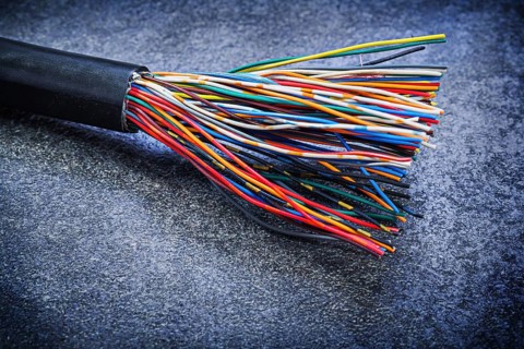 Multicolored electric wires on black background electricity concept